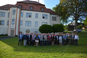 viele Personen auf WIese vor Schloss